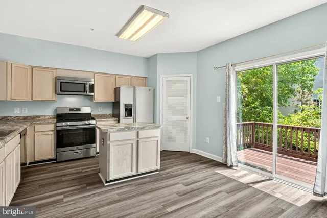a kitchen with a stove a sink and a microwave