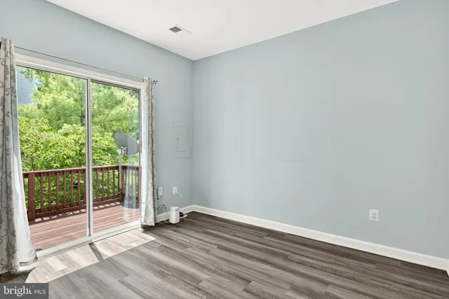 a view of wooden floor and window in an empty room