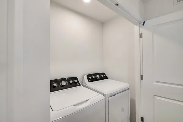 a view of washer and dryer with wooden floor