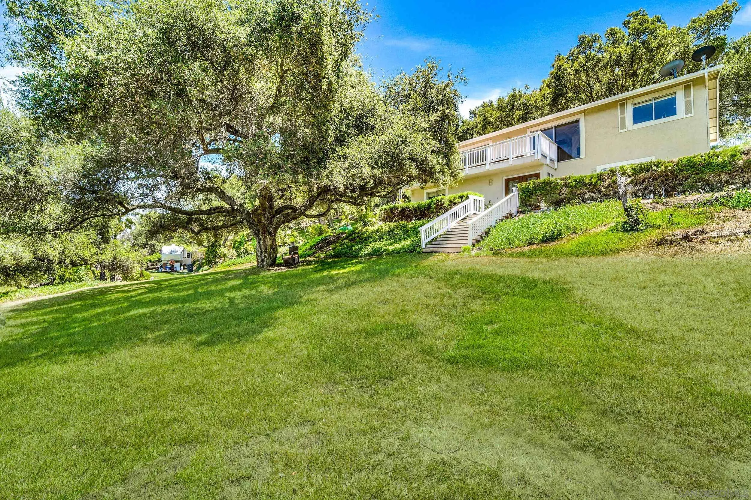 28517 Valley Center Road Valley Center, CA 92082 - Photo 3 of 55 a view of a yard in front of a house