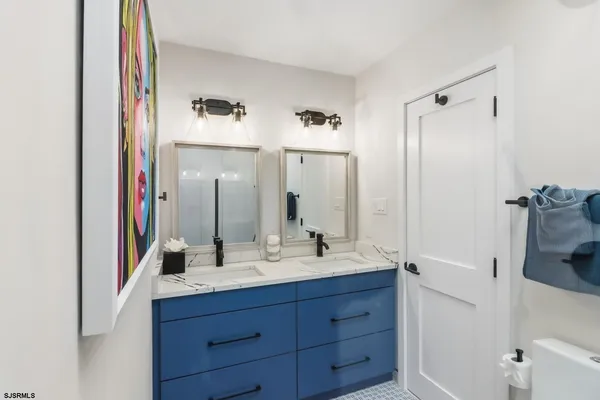 a bathroom with a double vanity sink and mirror