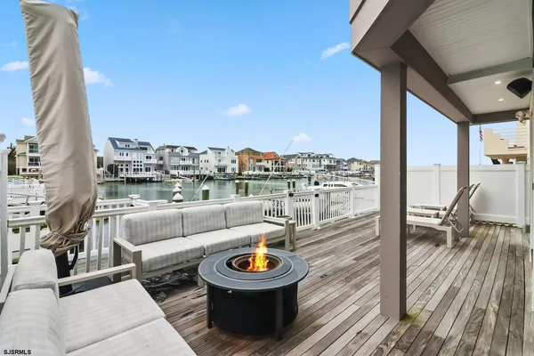 a living room with patio furniture and a wooden floor