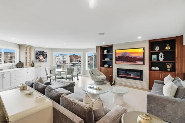 a living room with furniture a flat screen tv and white walls