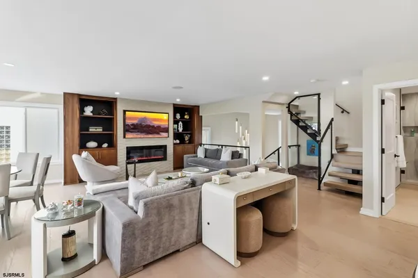 a living room with furniture and a view of kitchen