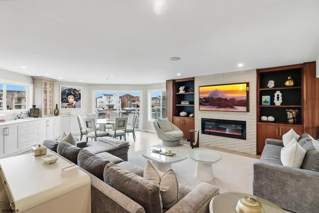 a living room with furniture a flat screen tv and white walls