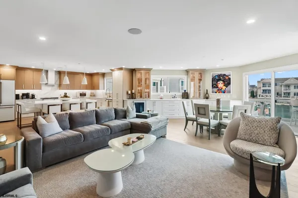 a dining area with a table chairs and a kitchen view