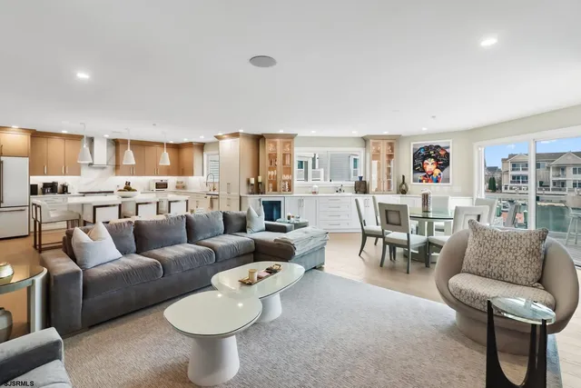 a dining area with a table chairs and a kitchen view
