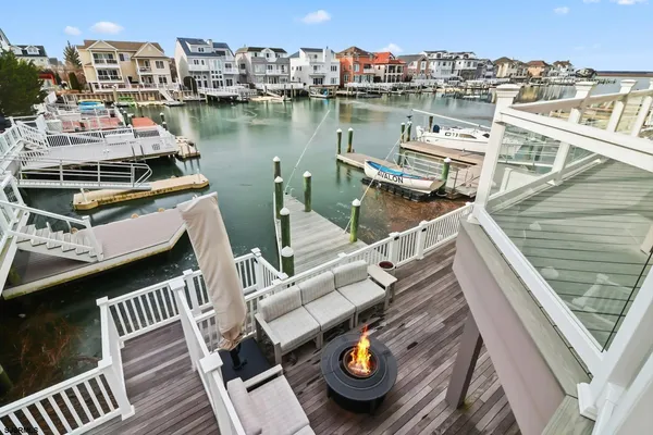 a view of a roof deck with couches and wooden floor