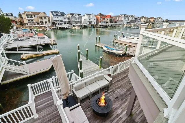 a view of a roof deck with couches and wooden floor