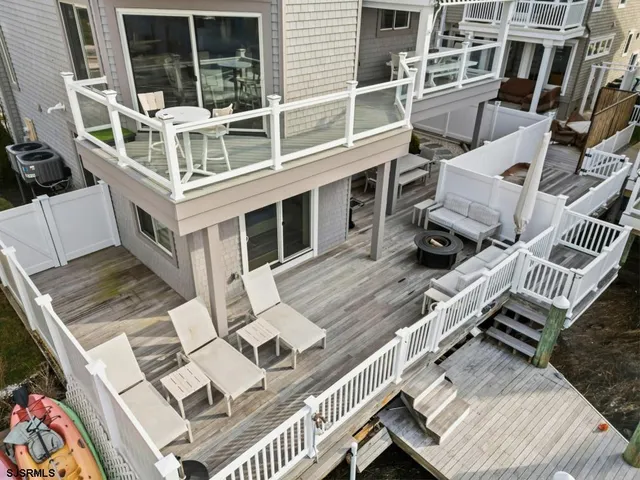 a kitchen with stainless steel appliances kitchen island granite countertop a refrigerator and a stove top oven