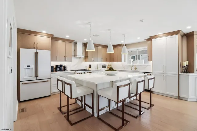 a kitchen with stainless steel appliances a sink stove and cabinets
