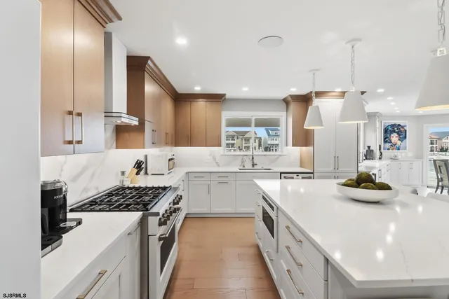 a kitchen with cabinets and chairs