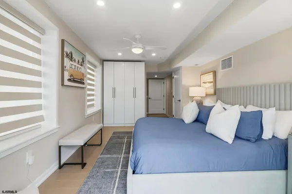 a spacious bedroom with a large bed and a couch