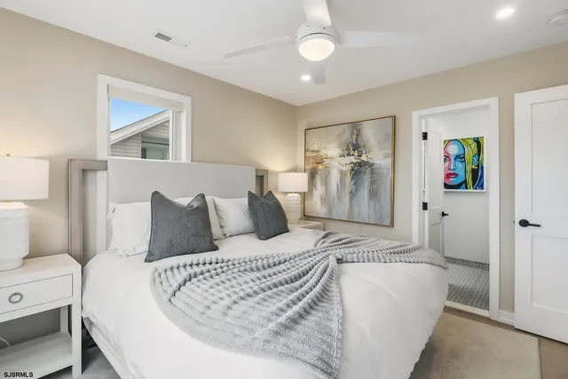 a bedroom with a large bed and a window