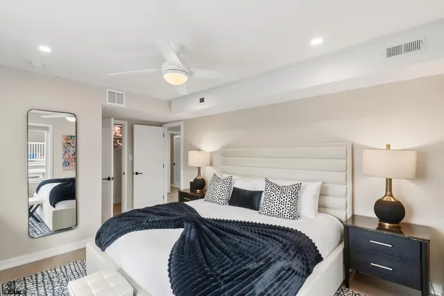 a bathroom with a shower sink vanity mirror and toilet