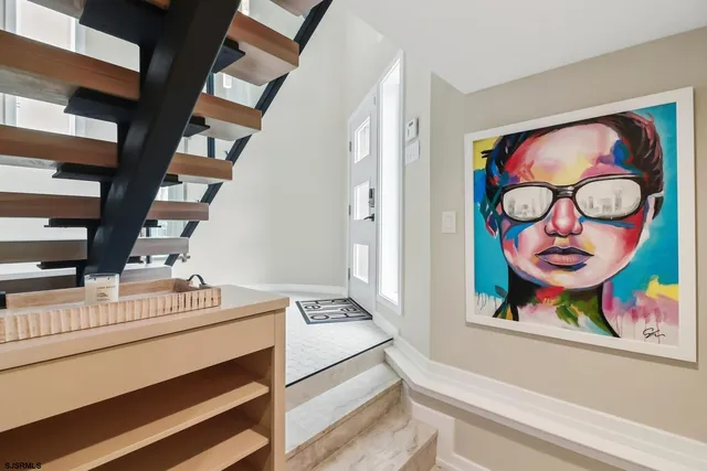 a cabinet with view of painting on the wall and a window