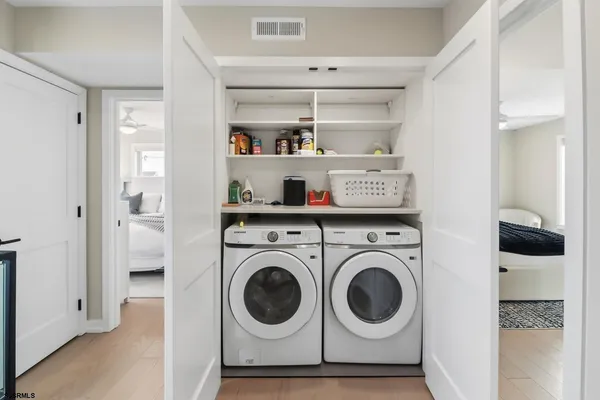 a bedroom with a bed and a painting on the wall