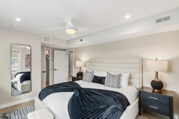 a bedroom with a bed and a large window