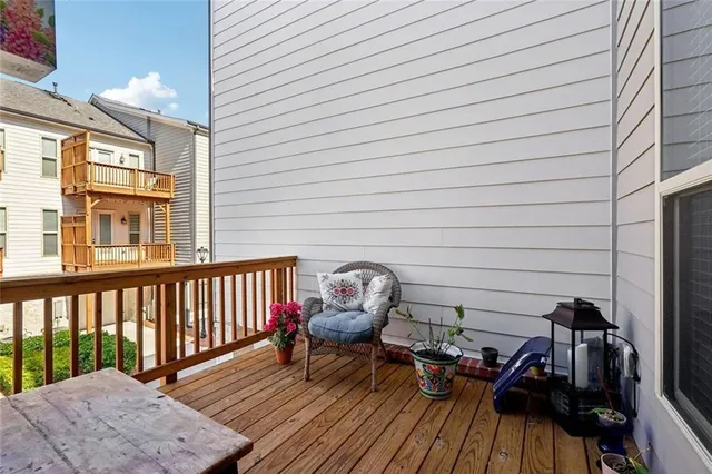 a view of balcony with wooden floor and outdoor seating