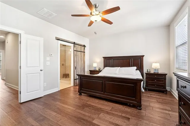 a bedroom with a bed and wooden floor