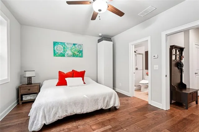 a bedroom with a bed and a large mirror