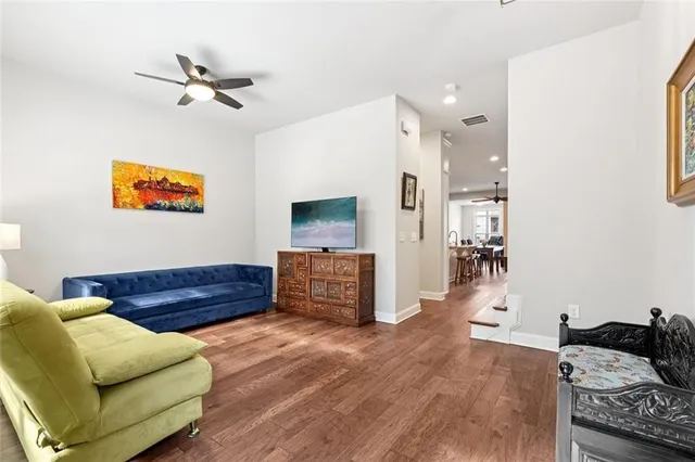 a living room with furniture and a wooden floor