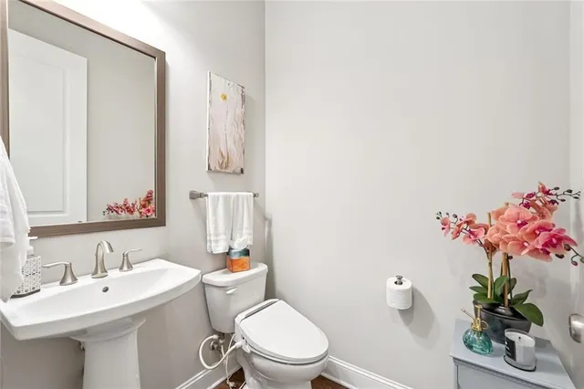 a bathroom with a sink mirror and toilet