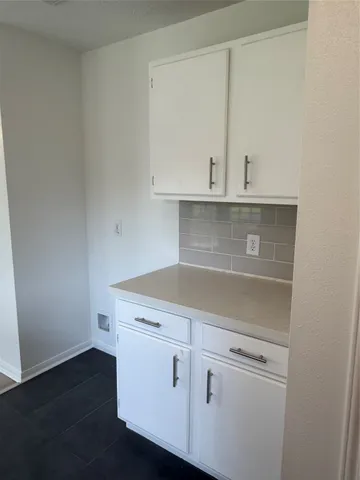a view of cabinets and wooden floor