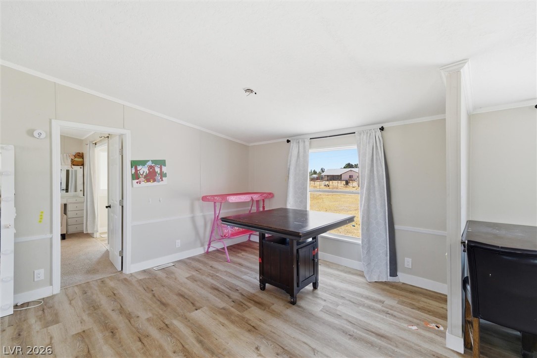 4331 Retread Road Pahrump, NV 89048 - Photo 13 of 31 Laminate flooring extends into this bright, airy room with views of the pastoral surroundings.