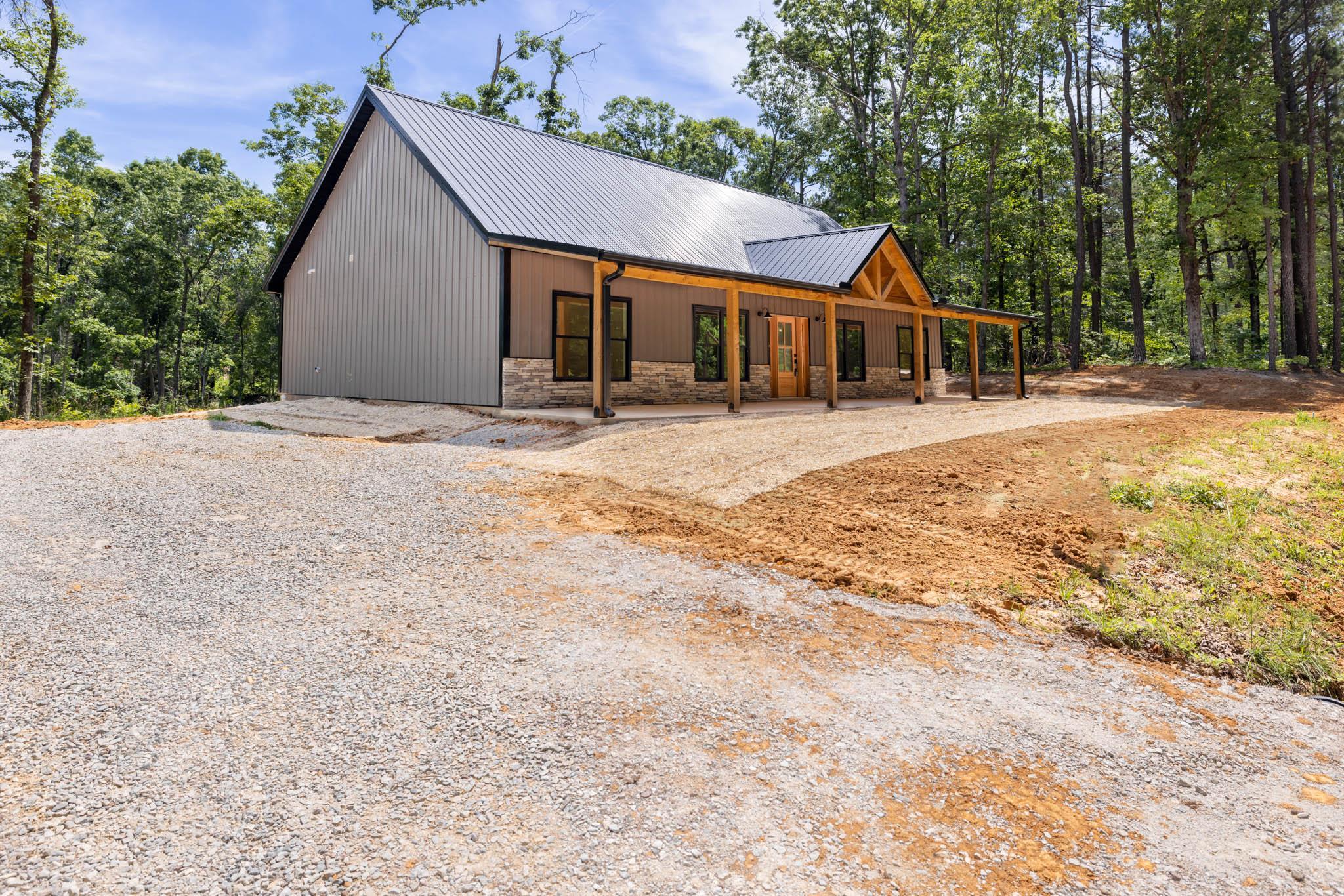 37 William Teague Lane Ramer, TN 38367 - Photo 3 of 39 Modern barndominium-style residence featuring a metal roof and board-and-batten siding