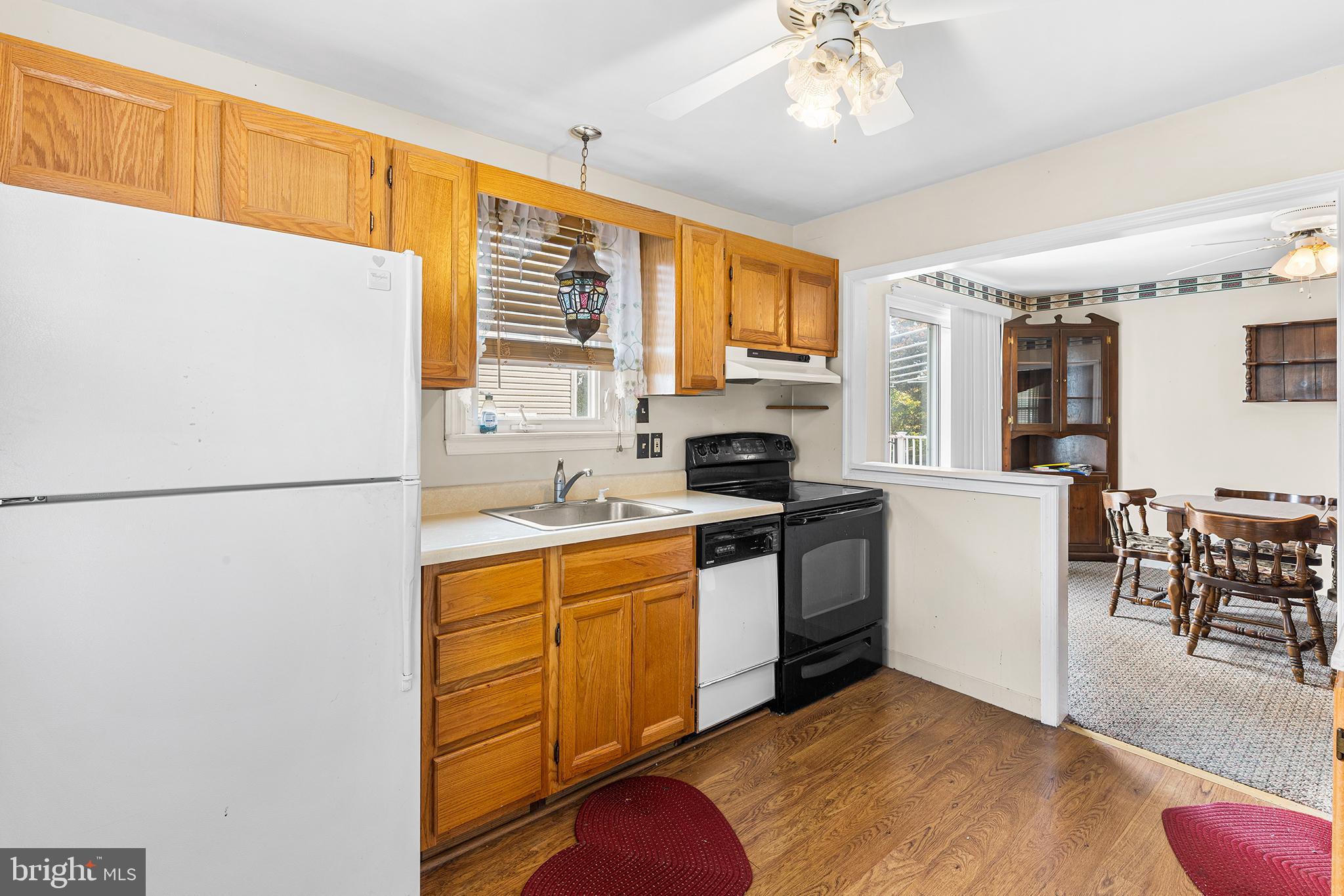 2839 Springfield Road Broomall, PA 19008 - Photo 8 of 18 a kitchen with stainless steel appliances granite countertop a refrigerator a sink dishwasher a stove with white cabinets and wooden floor