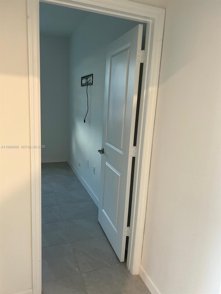 11859 Southwest 241st Street, Unit 1 Homestead, FL 33032 - Photo 4 of 7 a view of an empty room