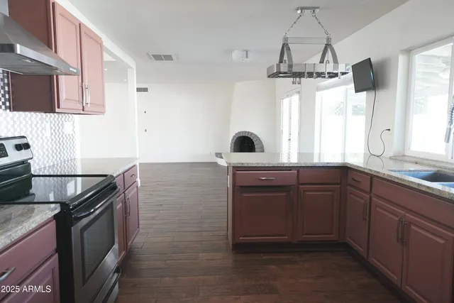 a kitchen with a sink stove and microwave