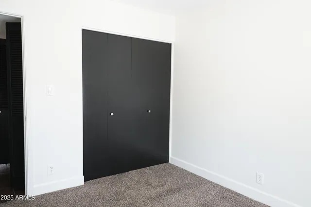 a bathroom with a granite countertop sink vanity and mirror
