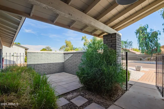 a view of a patio with table and chairs and potted plants