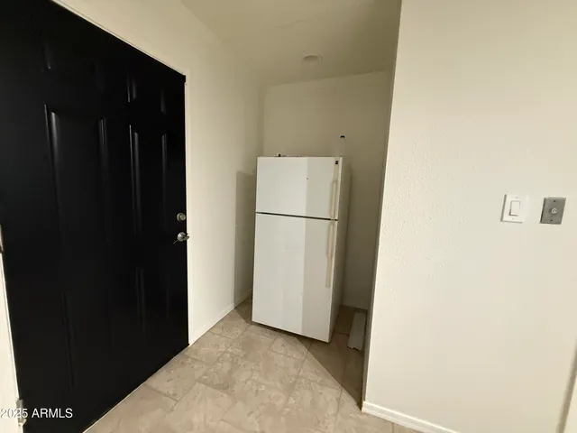 a room with water heater and a wooden floors