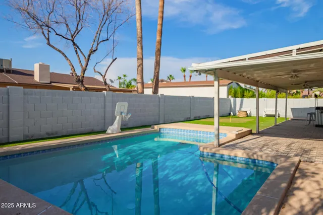 a view of a house with swimming pool and sitting area