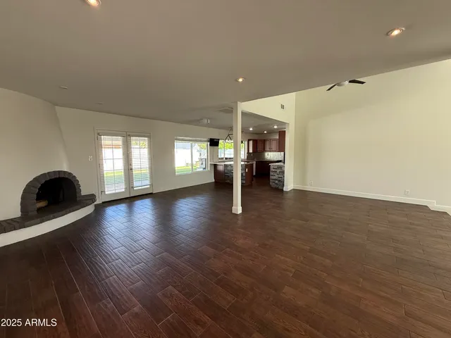 a view of a livingroom with kitchen and a window