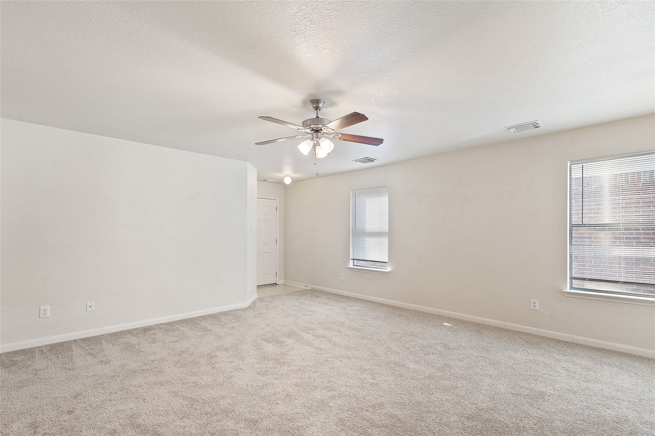 29522 Legends Stone Drive Spring, TX 77386 - Photo 5 of 17 an empty room with windows and chandelier fan