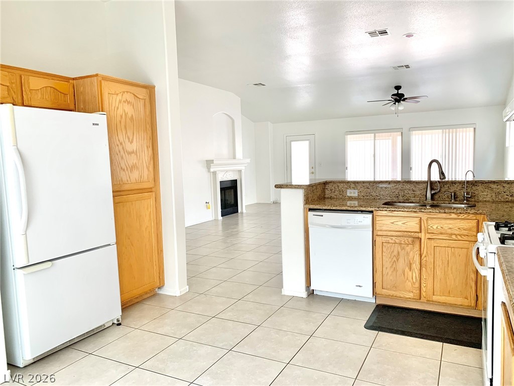 3821 Bombastic Court Las Vegas, NV 89147 - Photo 9 of 36 Bright, open-concept kitchen features a peninsula with integrated sink, offering seamless flow into the living area.