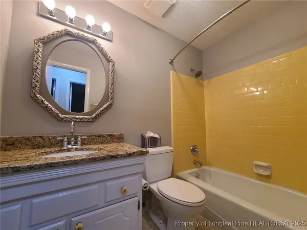 an empty room with a ceiling fan and window