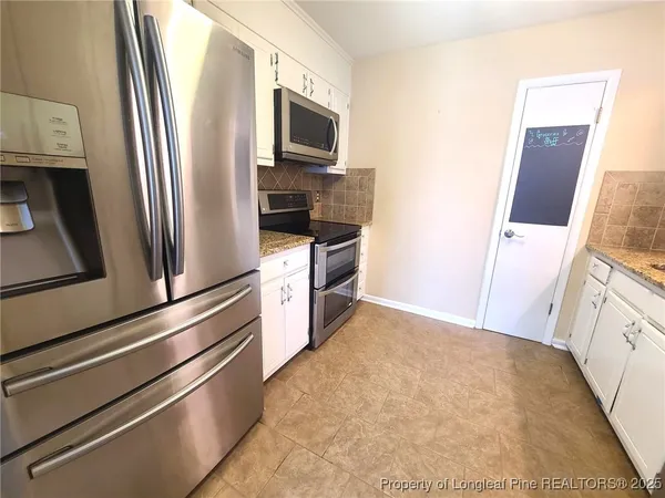 a kitchen with stainless steel appliances a refrigerator and a stove