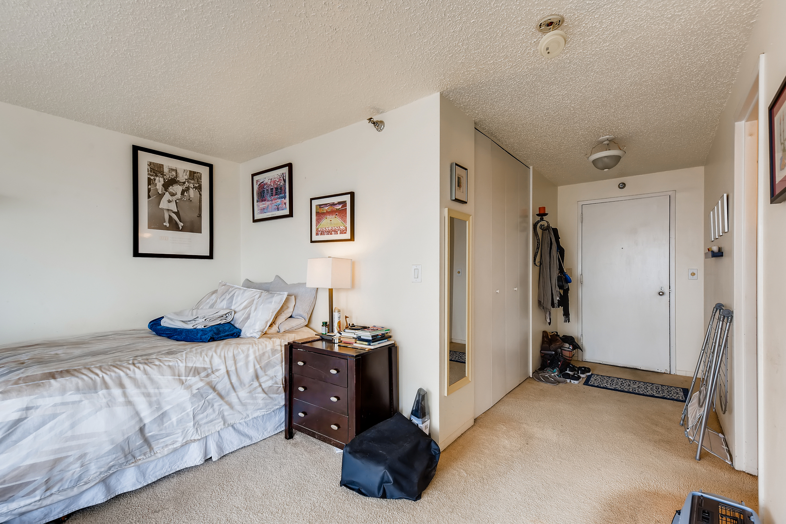 1122 North Clark Street, Unit 2207 Chicago, IL 60610 - Photo 12 of 14 a bedroom with bed and a couch