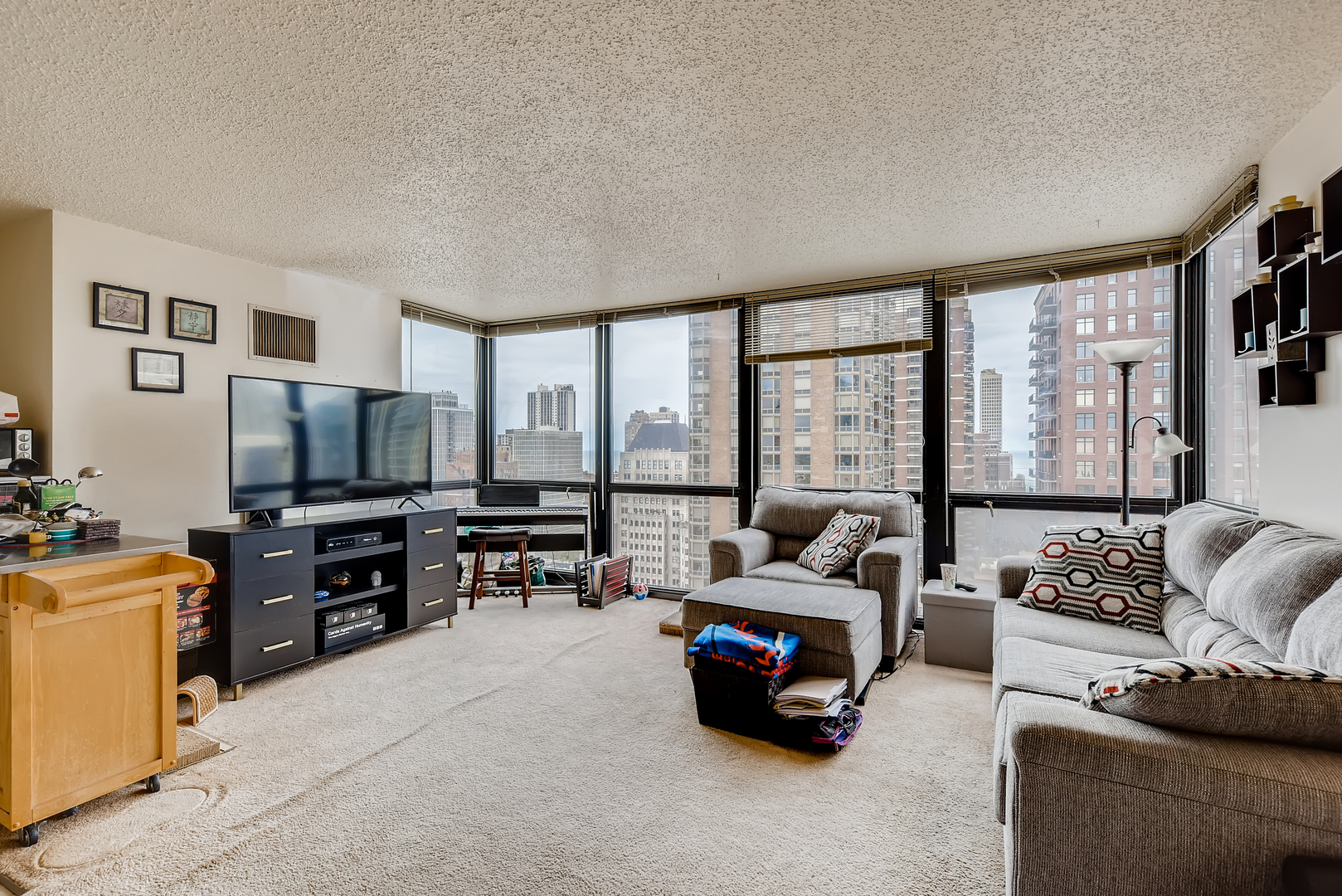 1122 North Clark Street, Unit 2207 Chicago, IL 60610 - Photo 5 of 14 a living room with furniture and a flat screen tv