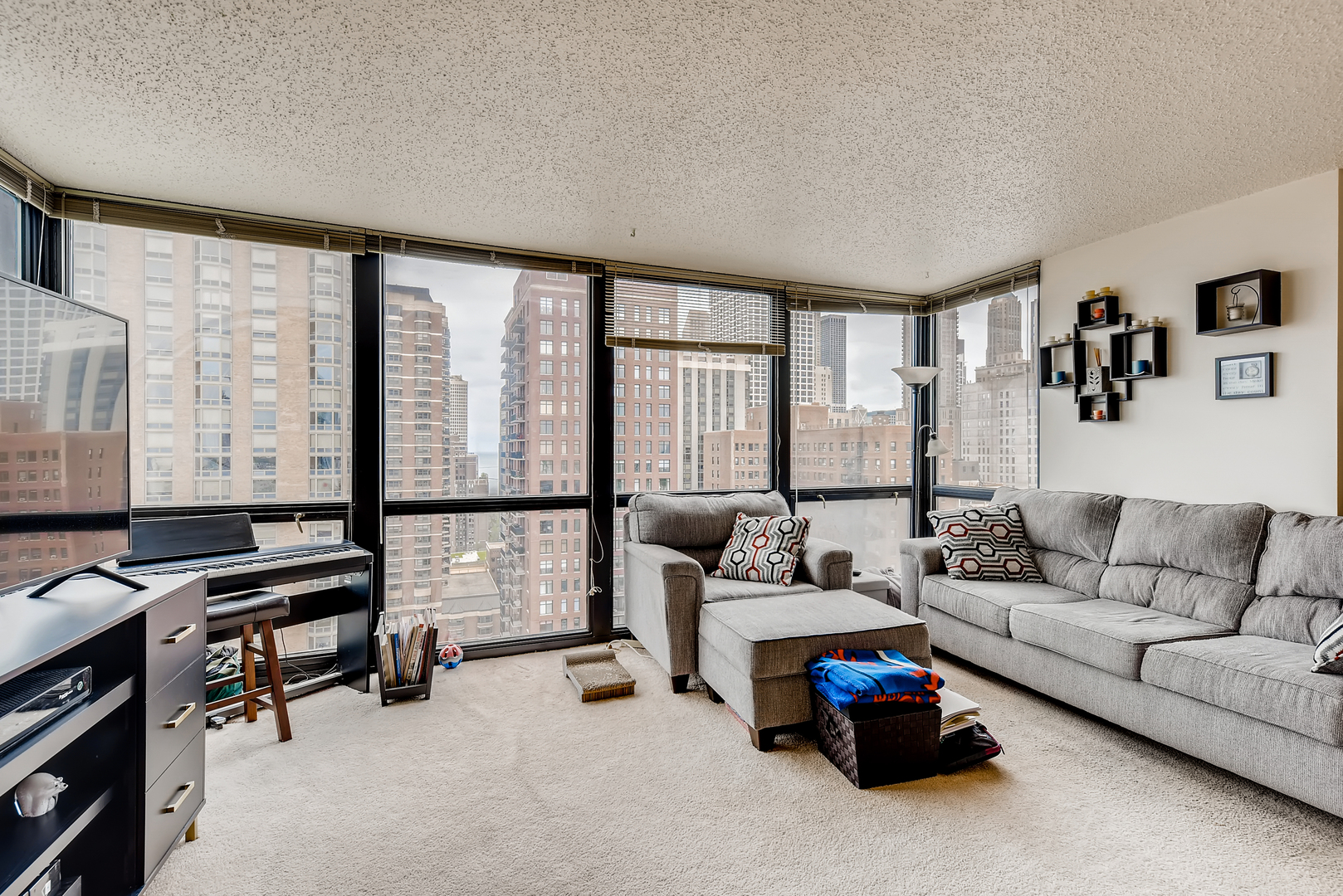 1122 North Clark Street, Unit 2207 Chicago, IL 60610 - Photo 6 of 14 a living room with furniture and a large window