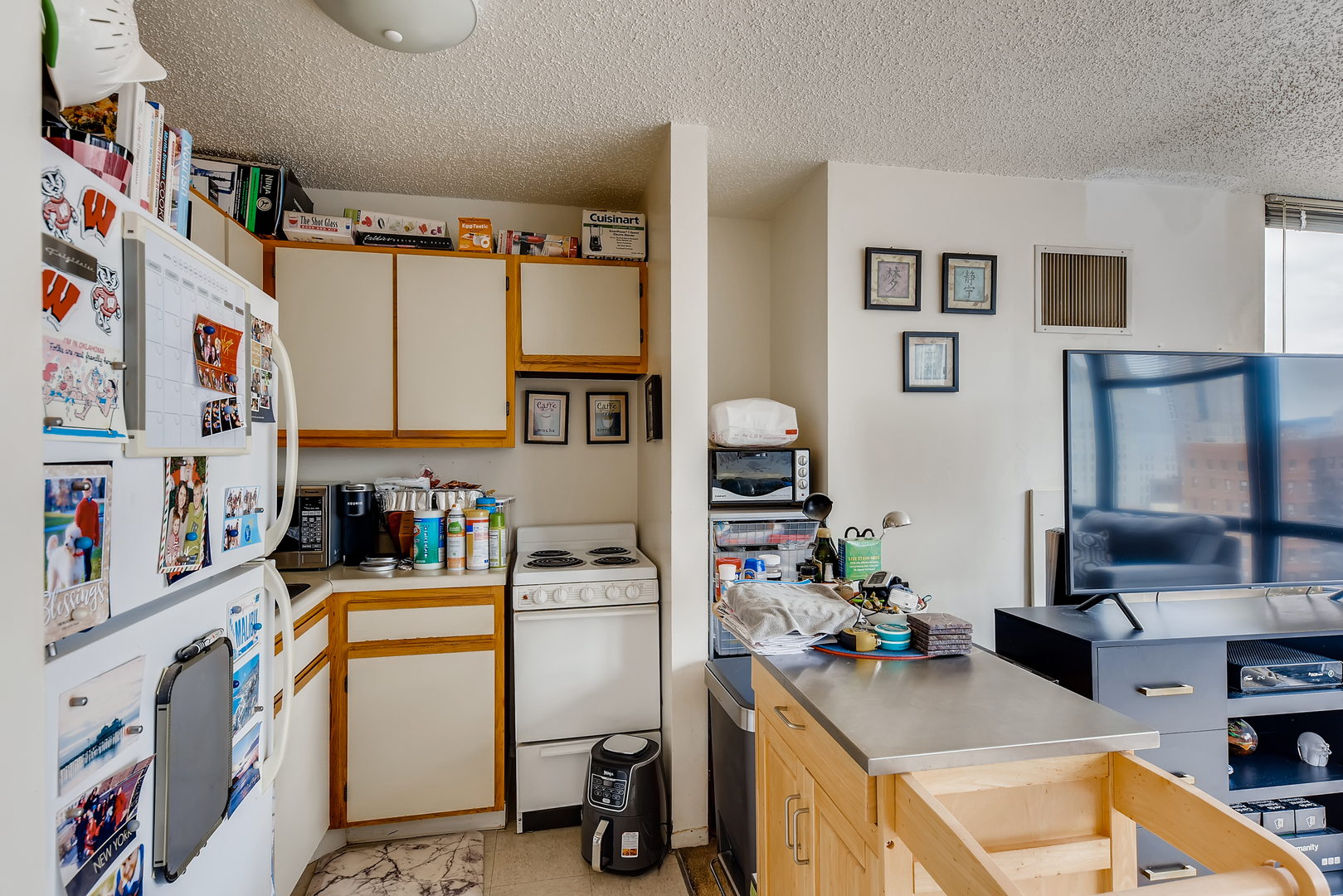 1122 North Clark Street, Unit 2207 Chicago, IL 60610 - Photo 10 of 14 a room with furniture a rug and a window