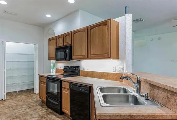 a kitchen that has a sink and a stove in it