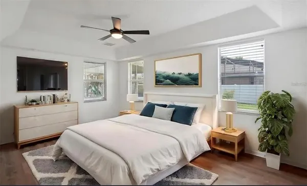 a bedroom with a bed and a flat screen tv