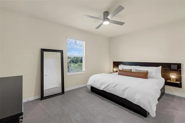 a bedroom with a large bed and a chandelier