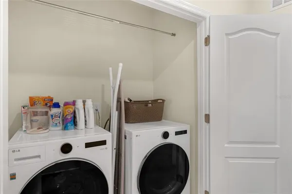 a view of washer and dryer with kitchen in the background